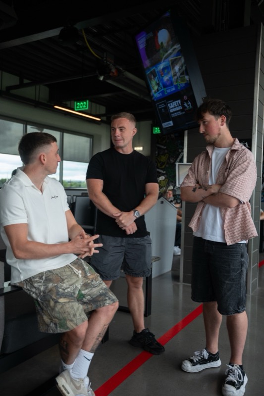 Three members talking at Topgolf