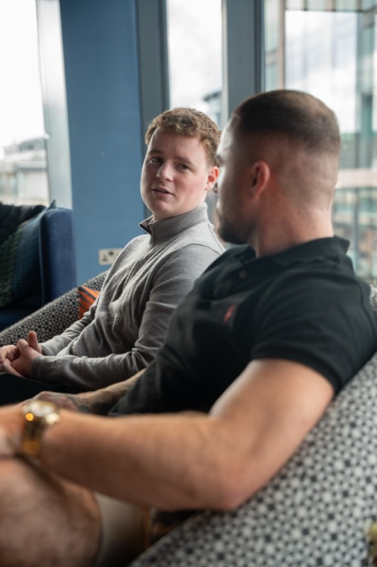 Two members talking on the sofa