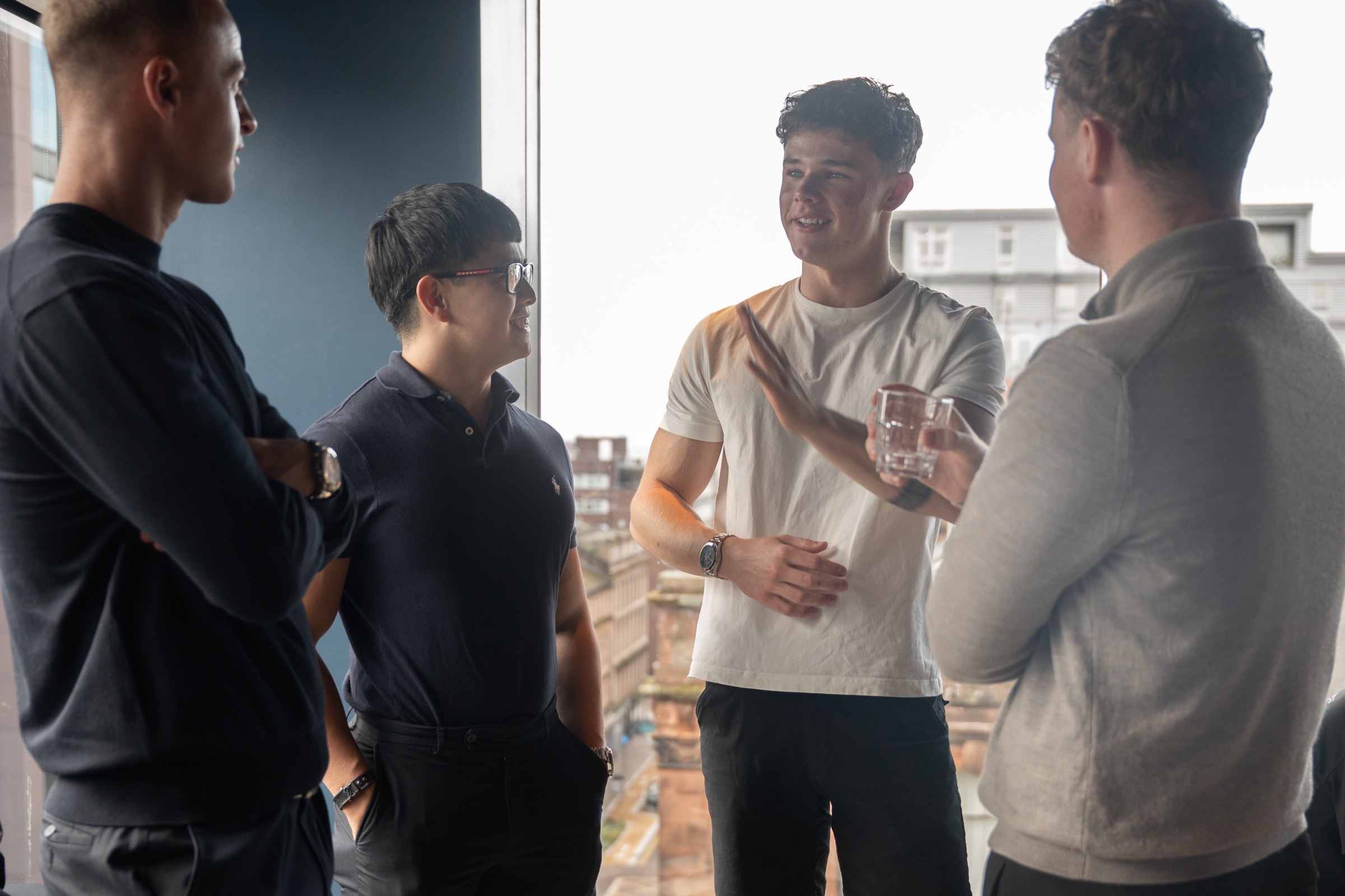 Members of The Right Room talking by the window at VEGA Glasgow